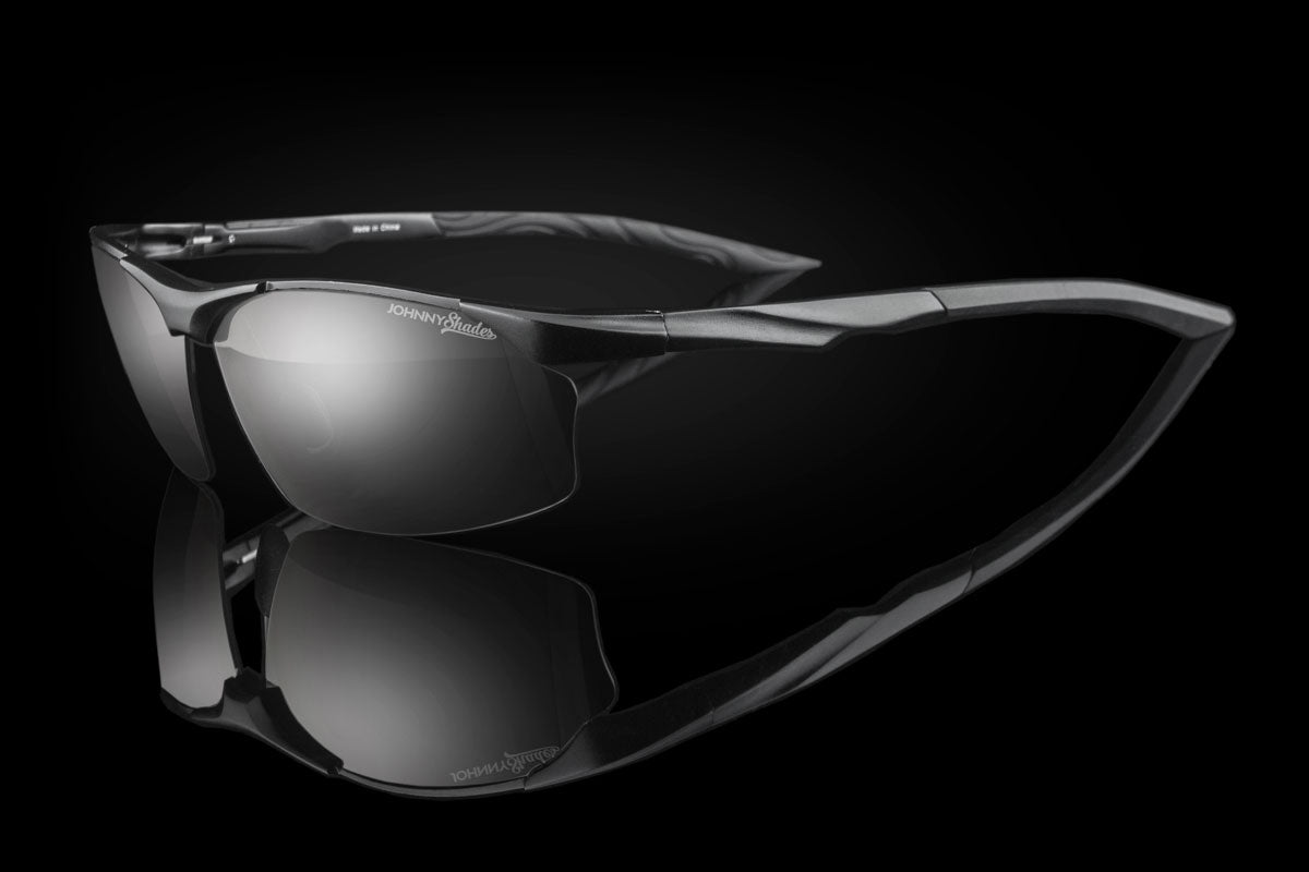 Black sunglasses with reflective lenses on a black background